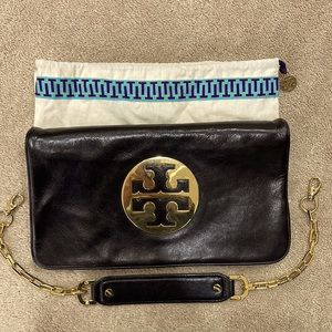 Beautiful leather Tory Burch clutch with gold hardware & strap.  Can’t go wrong!